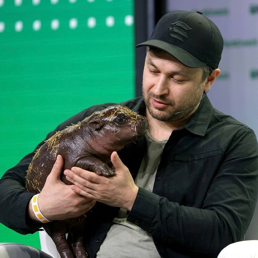 Anatoly Yakovenko holding baby hippo